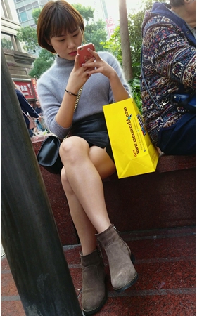 花坛边玩手机的短发美眉