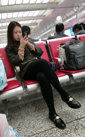 高铁站候车的黑色打底丝袜性感长腿美眉